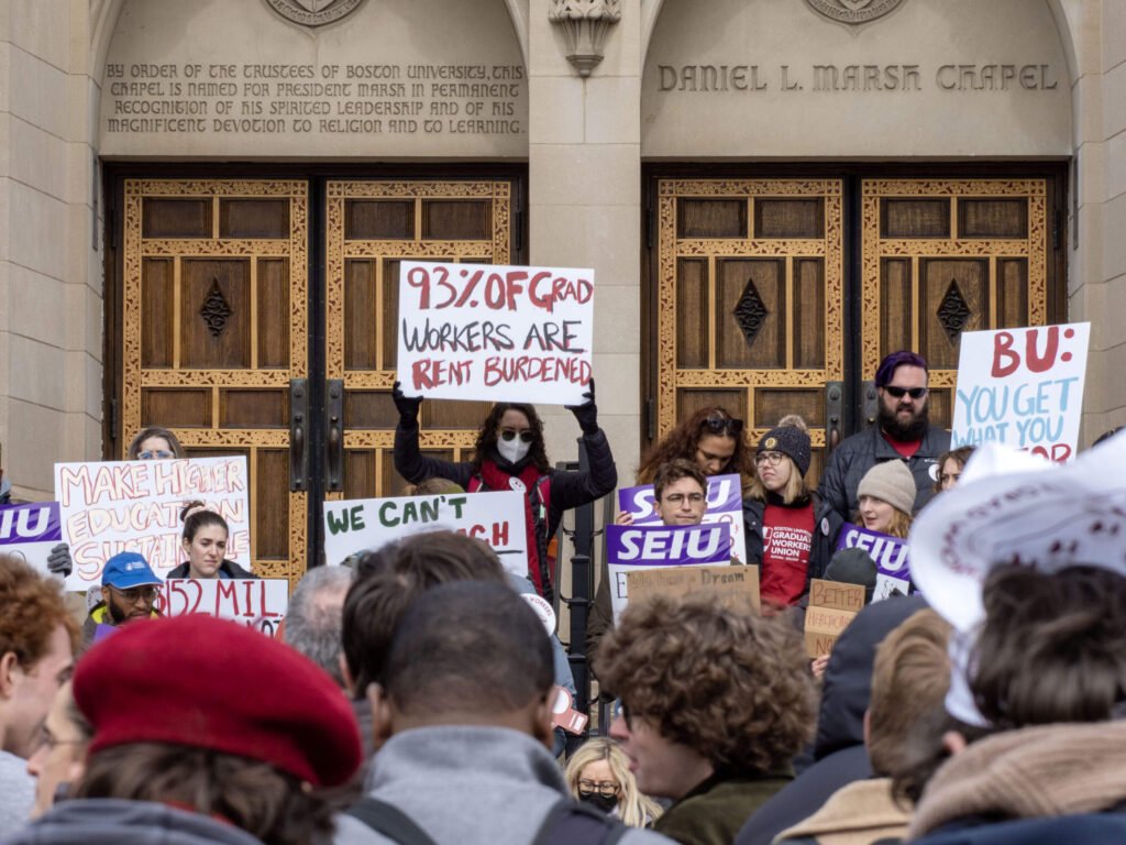 A group of BUGWU and SEIU strikers holding signs with messages such as, "93% of grad workers are rent burdened" and "make higher education sustainable."